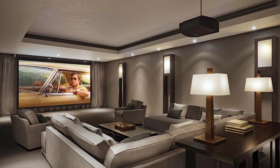 Home theater room with a projector and projection screen setup, comfy seating, and lamps in the foreground.